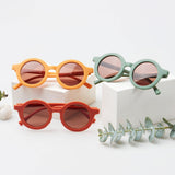 Kids UV sunglasses in yellow, green and orange