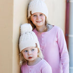 Matching girls cream winter cotton beanies with pom pom. Cubs & Co. Australia.