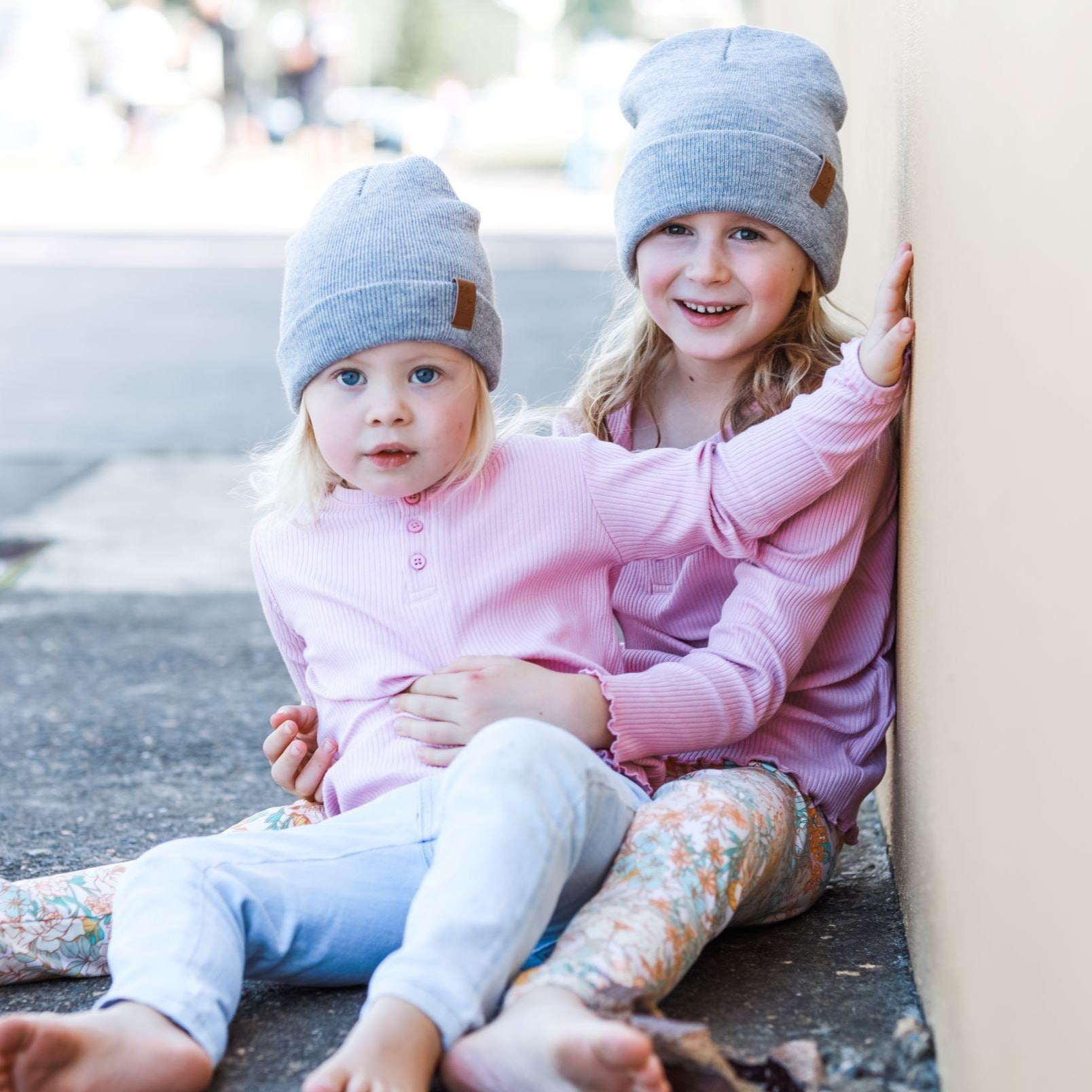 Girls wearing matching grey winter beanies. Cubs and Co. Australia