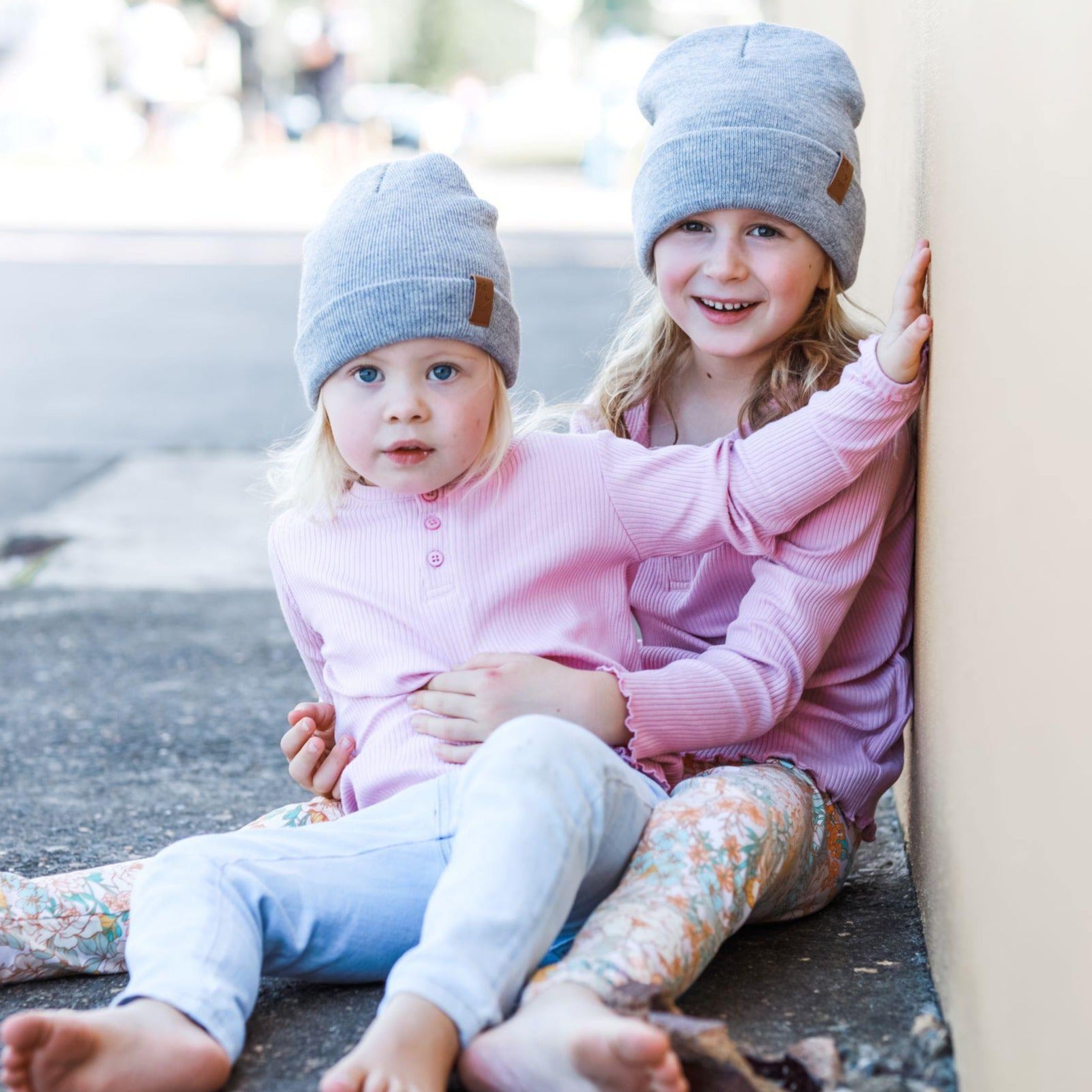 Girls wearing matching grey winter beanies. Cubs and Co. Australia