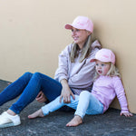 Matching mum and daughter wearing pink baseball caps. Cubs & Co. Australia 