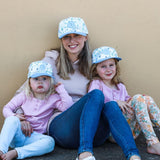 Matching mum and daughters wearing blue floral baseball snapback caps. Cubs & Co. Australia.