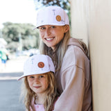 Mum and daughter wearing matching Paradise palm snapback baseball caps. Cubs & Co. Australia