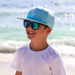 Boy wearing Blue Palm Tree snapback hat. Cubs & Co. Australia