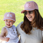 Mum and daughter wearing matching personalised pink baseball caps with their initials. Cubs & Co. Australia.