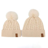 Matching cream winter cotton beanies with pom pom for kids, women and men. Cubs & Co. Australia.