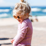 Girl wearing kids yellow butterscotch sunglasses with UV protection. Cubs & Co. Australia